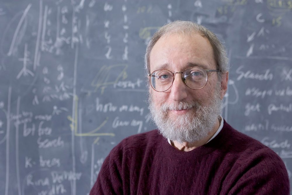 Professor Eugene Freuder of UCC standing in front of a blackboard with numbers written on it