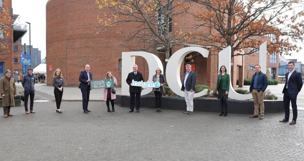 Group photo of Vision Sports project leads infront of DCU sign