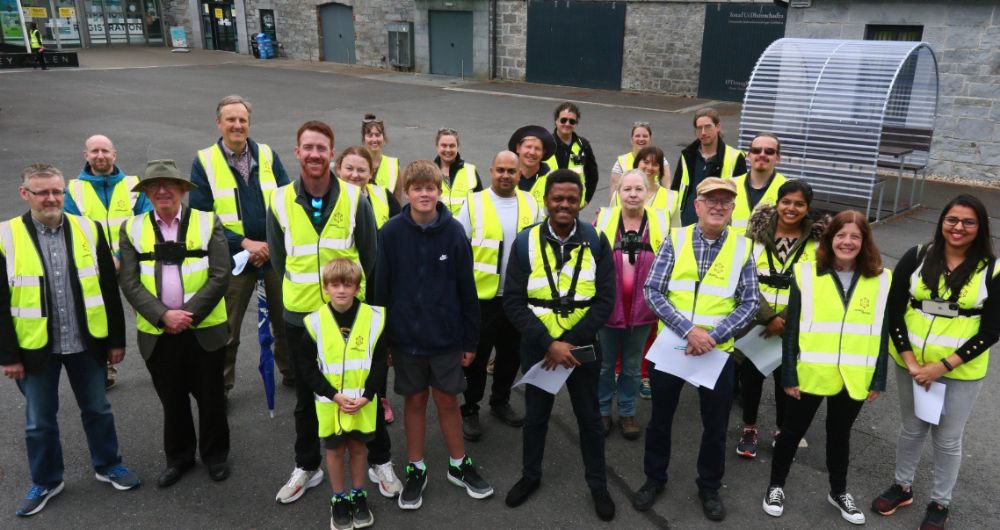 Group of Crowd4Access volunteers in hi-vis vests, standing outside at University of Galway