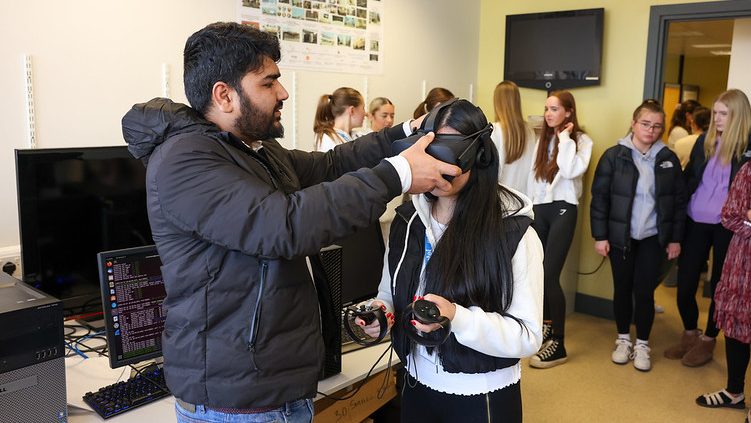 Abid Yaqoob helps TY student to put on a VR headset