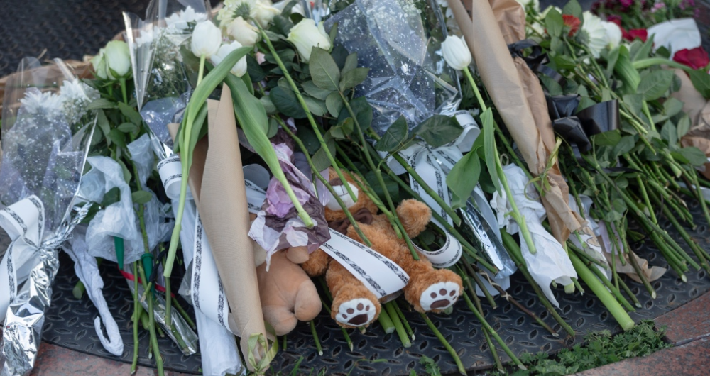 flowers and toys at an informal mass shooting memorial in Serbia