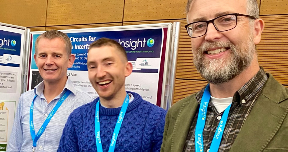 Brain Caulfield, Ciaran Purcell and Tomás Ward in front of a poster